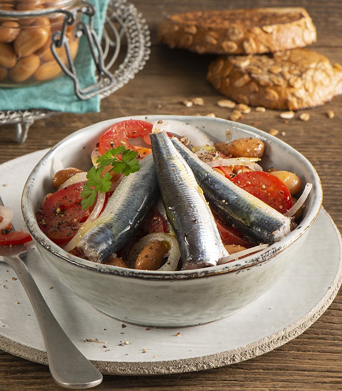 Sardine con insalata di pomodori, fagioli e cipolle marinate